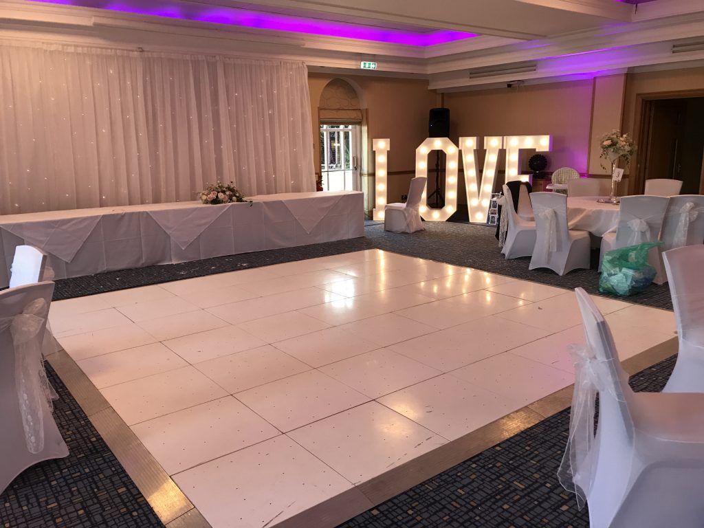 Pure white non led dance floor in front of the top table