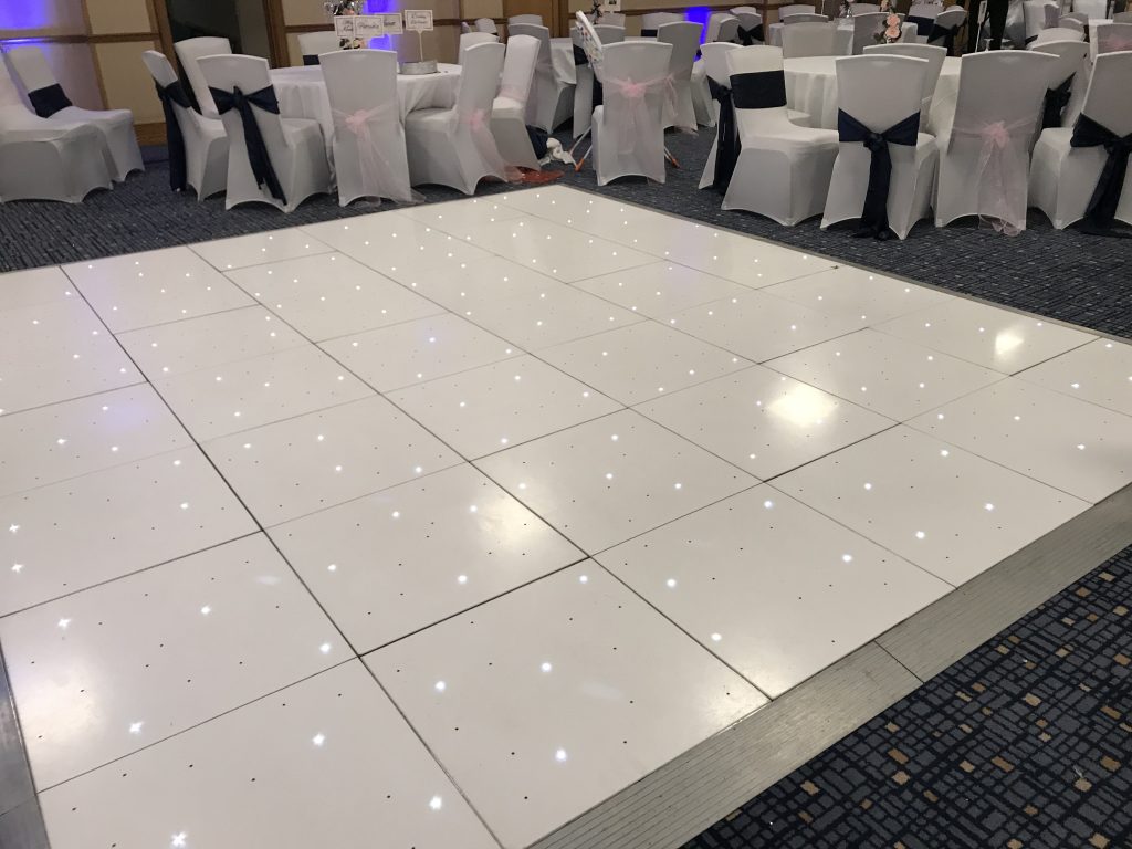 White led starlit dance floor with wedding tables around