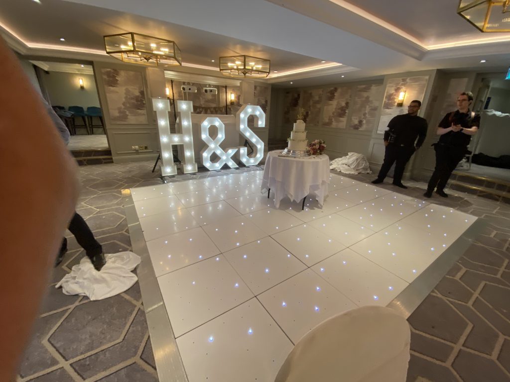 White starlit dance floor with H and S light up letters behind