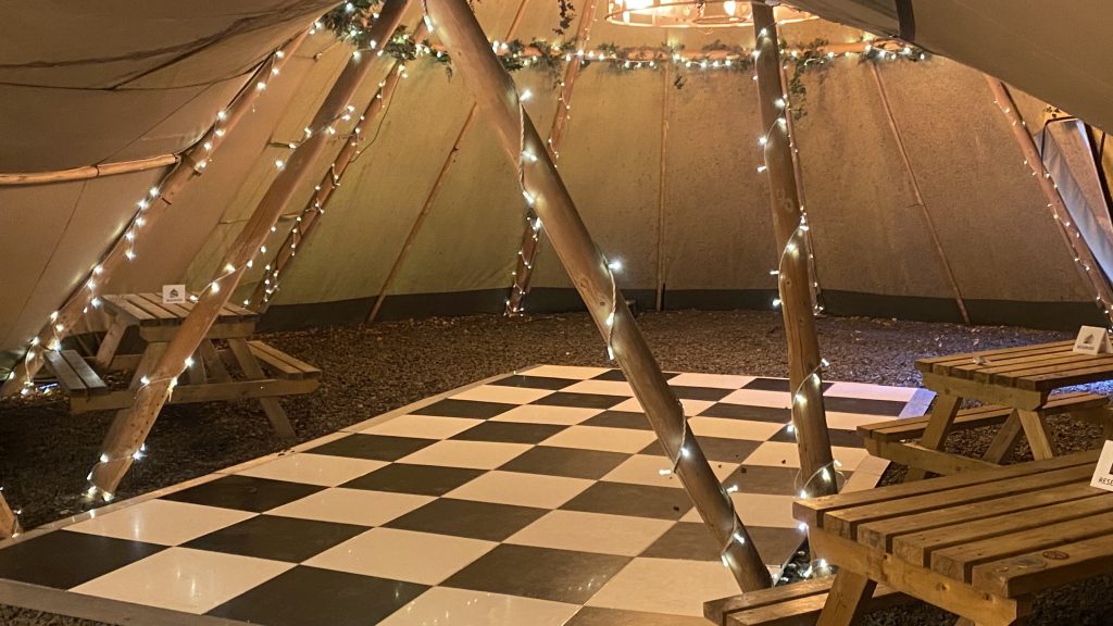 black and white chequered dance floor in a tipi tent