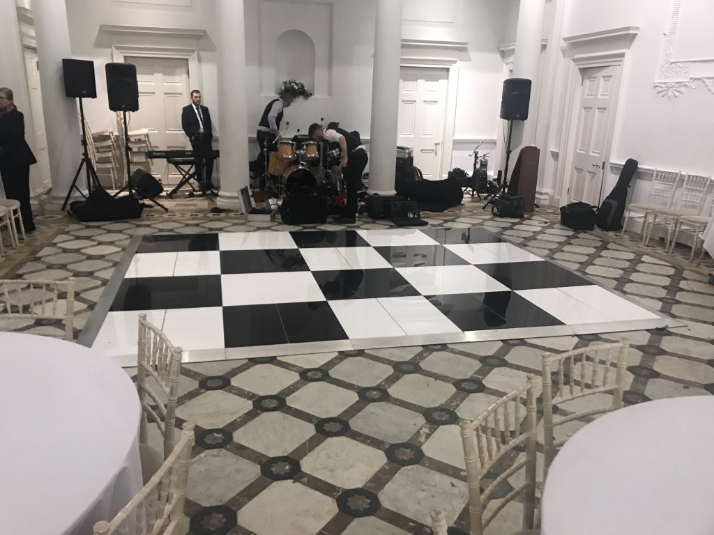 black and white chequered dance floor with band setting up