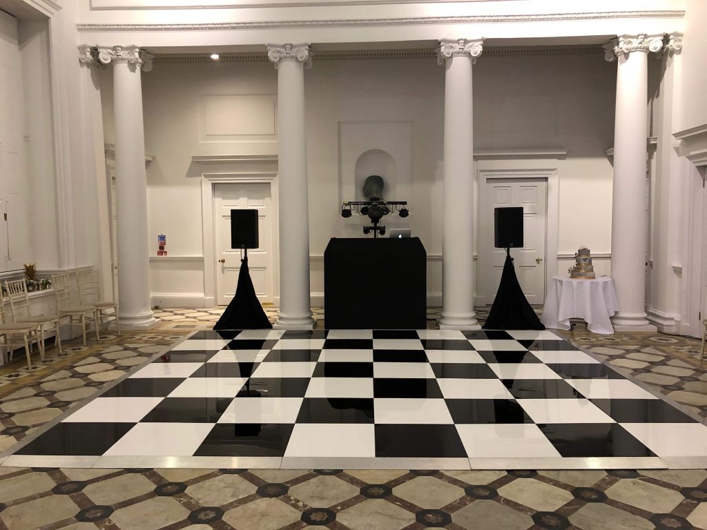 black and whtie dance floor with DJ setup