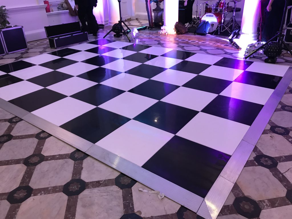 black and white chequered dance floor with band