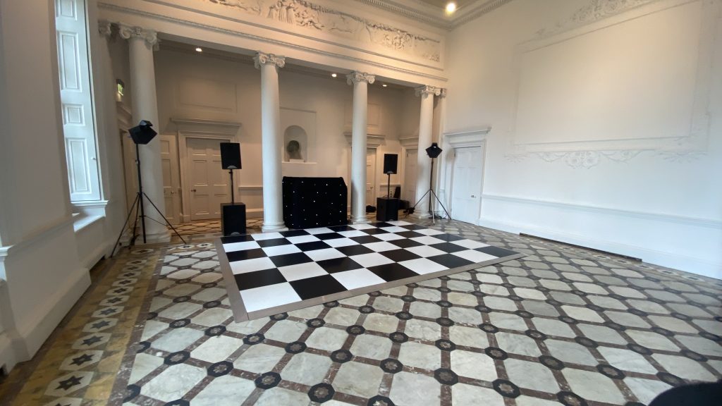black and white dance floor with DJ setup