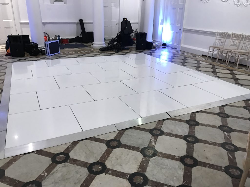 pure white dance floor with band setting up behind
