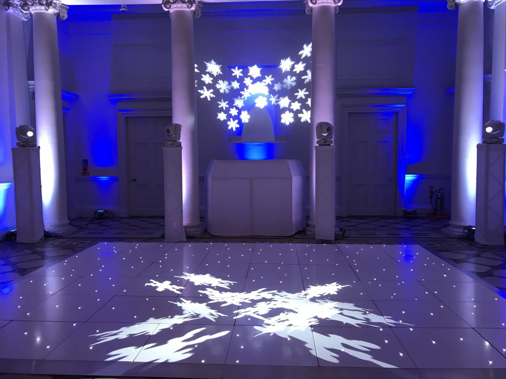 white starlit dance floor with snow flake light projections