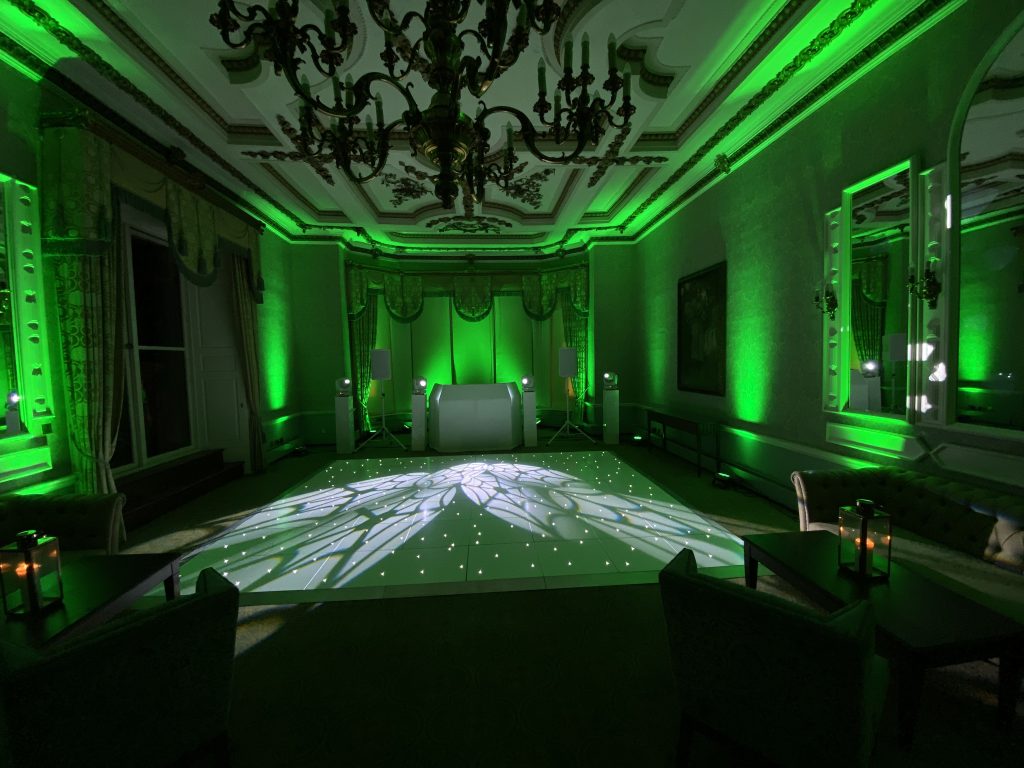 white starlit dance floor with green and white lighting before a first dance