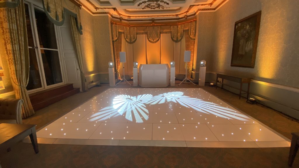 White starlit dance floor in from of a white disco and orange lighting