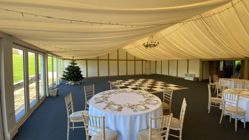 Black and white dance floor setup in space in a marquee for a wedding
