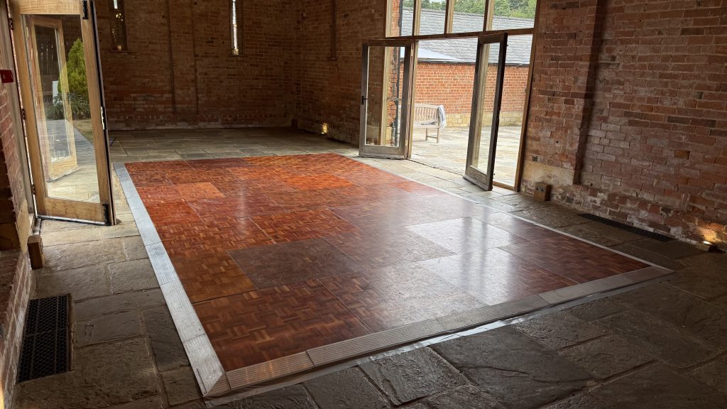 Wooden parquet dance floor in a barn at mickleton hill farms wedding venue