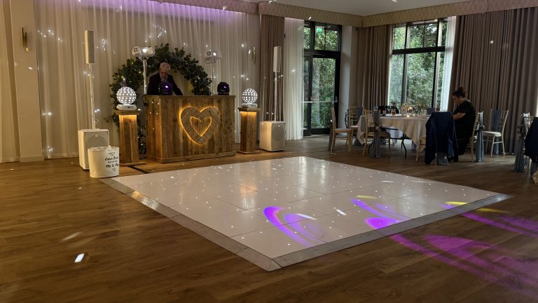 White starlit led dance floor with a rustic dj setup at the wood norton hotel evesham