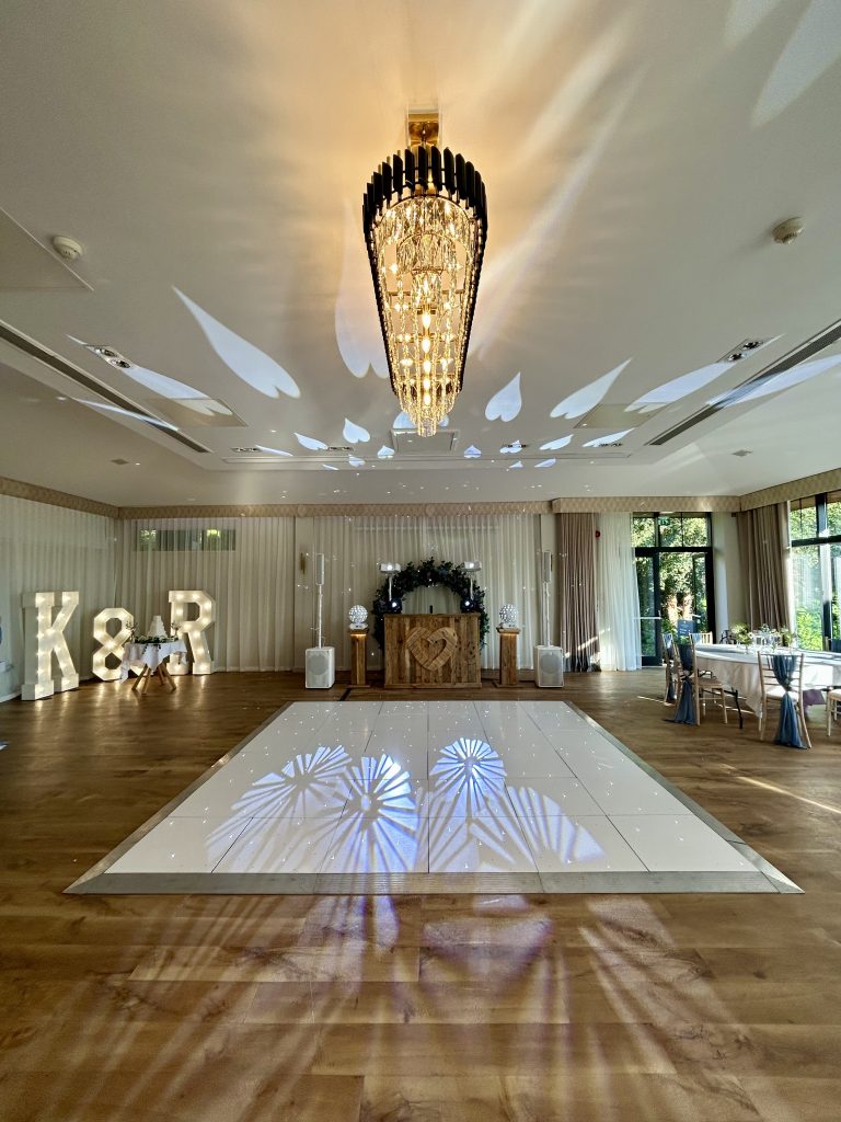 White starlit led dance floor with light up lettters K & R and a rustic dj setup at the wood norton hotel evesham