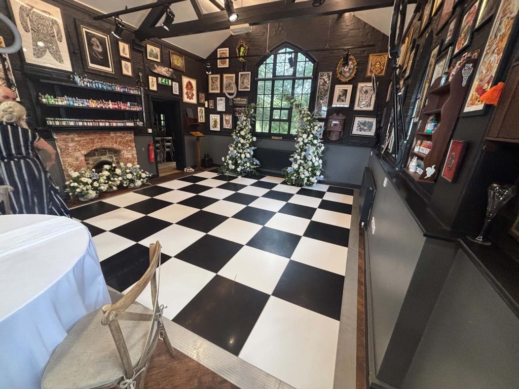 black and white dance floor setup in a tattoo studio for a wedding