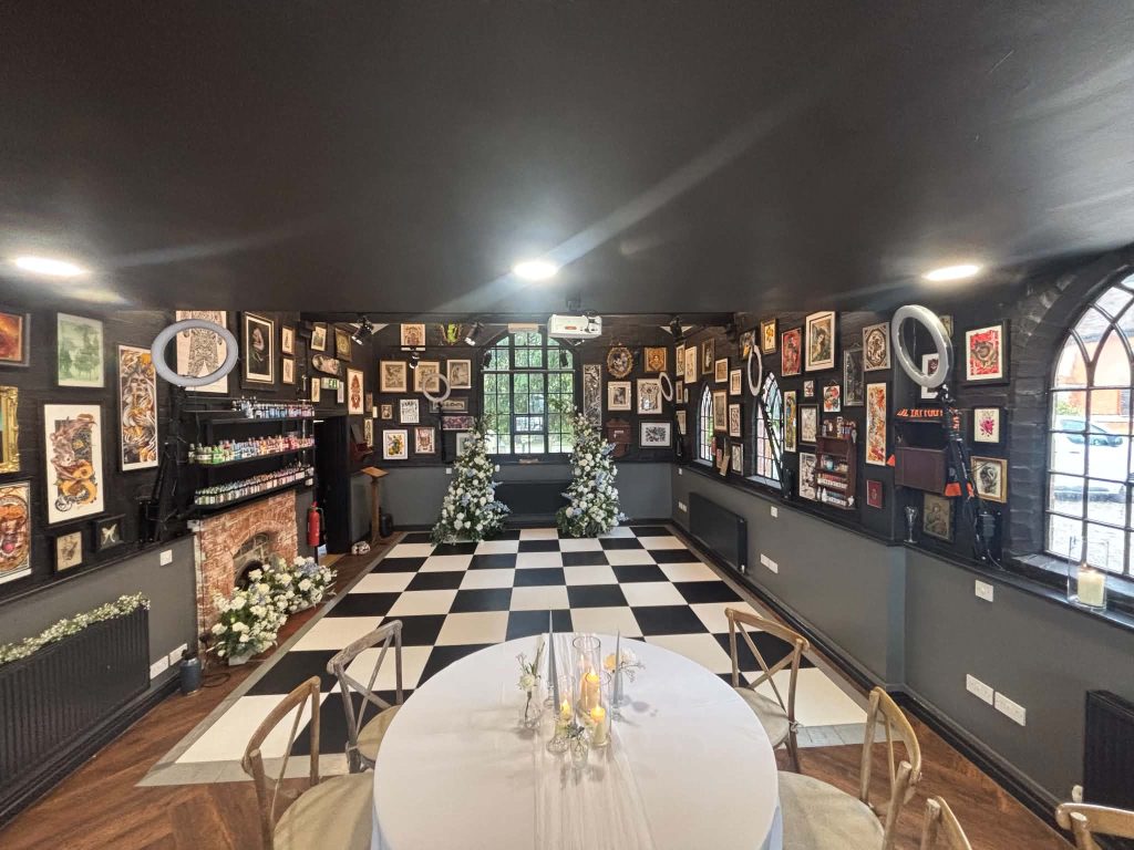 wide shot of a black and white dance floor for a wedding in a tattoo studio
